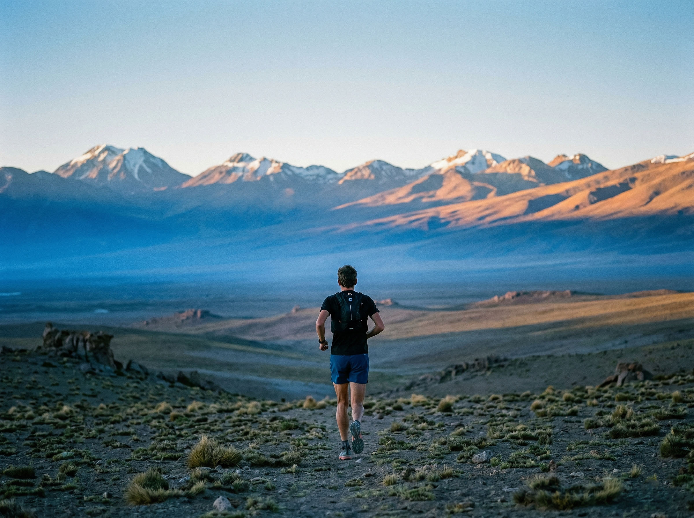A man running at high altitude in the Andes, illustrating genetic and physiological adaptations to thin-air environments
