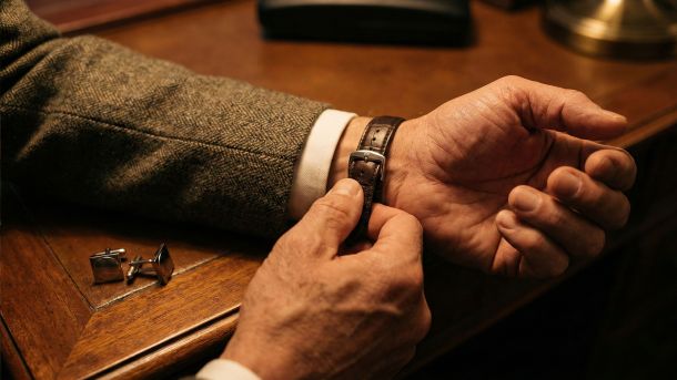 A man preparing with focus and attention to detail, symbolizing masculine competence.