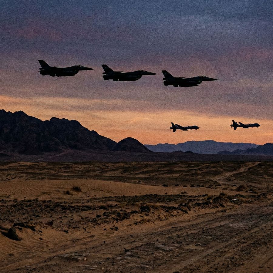 Military aircraft flying over a desert landscape during a strategic operation.