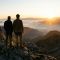 A father and son observing a mountain landscape, symbolizing guidance and the passing of a masculine legacy.