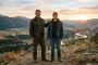A father and son standing together at golden hour, representing masculine strength, fatherhood, and family legacy