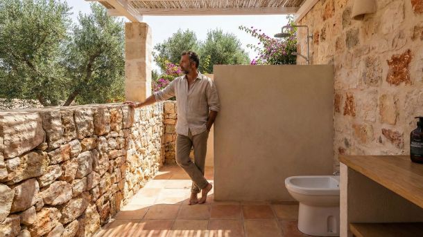 A clean, traditional Mediterranean bathroom setup highlighting a bidet for masculine hygiene.