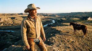 A strong man overlooking a mountain range representing traditional masculine virility and the provider role.