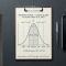Une règle métallique à côté d’un clipboard montrant une courbe de distribution statistique — représentant les données cliniques de la méta-analyse de 2015 sur la taille du pénis auprès de 15 521 hommes.