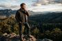 A determined man overlooking a valley, representing masculine health and generational legacy.