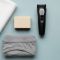 Men’s genital care essentials—towel, mild soap, trimmer, and cotton underwear in pastel tones
