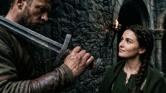 A man's hands gripping a traditional symbol of heritage and protection.