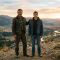 A father and son standing together at golden hour, representing masculine strength, fatherhood, and family legacy