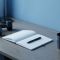 Minimal desk scene with coffee, notebook, and dumbbells in cool blue tones symbolizing a clear health plan for men